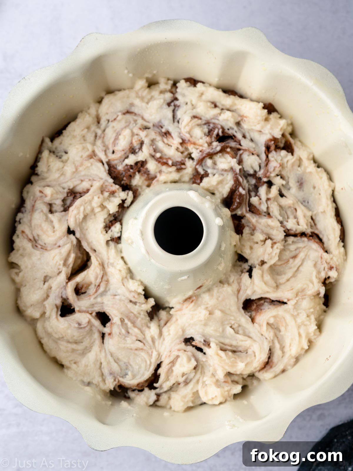 Moist Eggless Marble Cake Recipe for Perfect Swirls 12 Marbled cake batter in a bundt pan.