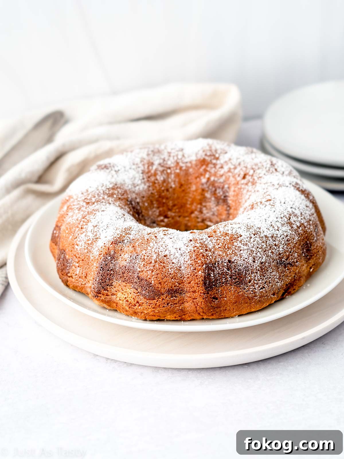 Moist Eggless Marble Cake Recipe for Perfect Swirls 3 Marble bundt cake topped with powdered sugar.
