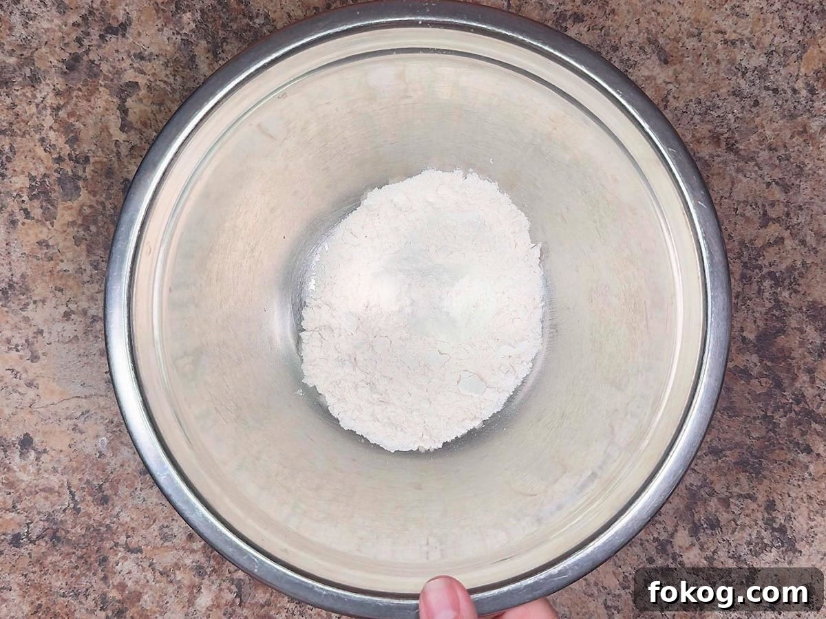Mini Corn Dog Bites Recipe: Crispy, Bite-Sized Snack Ideas 15 Measuring out flour in a separate mixing bowl.