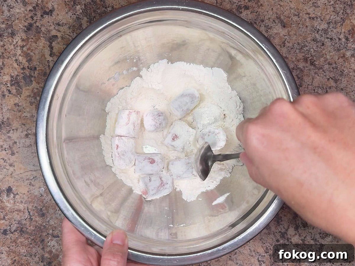 Mini Corn Dog Bites Recipe: Crispy, Bite-Sized Snack Ideas 17 Coating the hot dog pieces in flour.