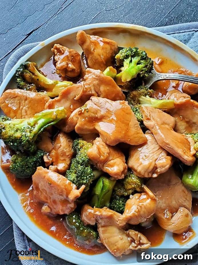 Chinese Chicken and Broccoli in the Instant Pot: Quick Weeknight Meal 5 instant pot Chinese chicken and broccoli in a white plate with a spoon
