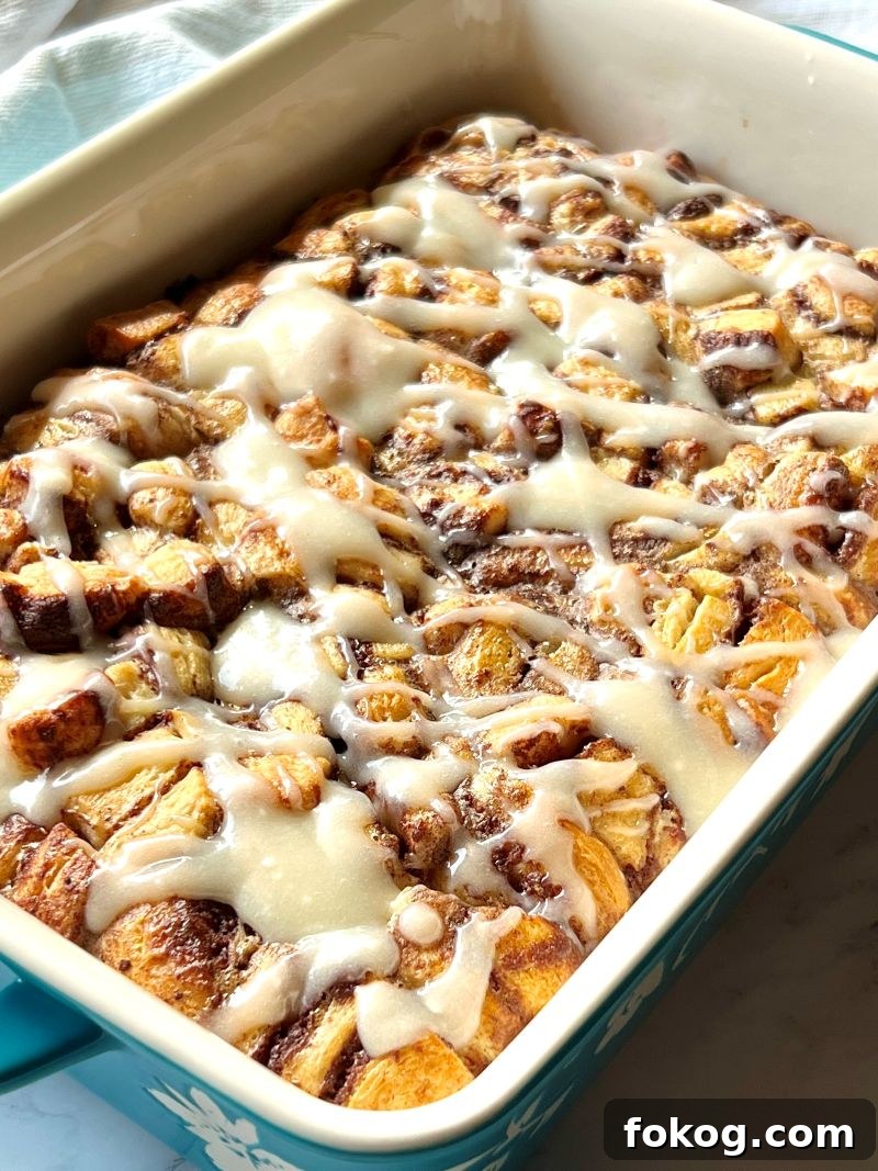 Cinnamon Roll French Toast Casserole Recipe for Brunch Bliss 10 Icing drizzled over baked cinnamon rolls.