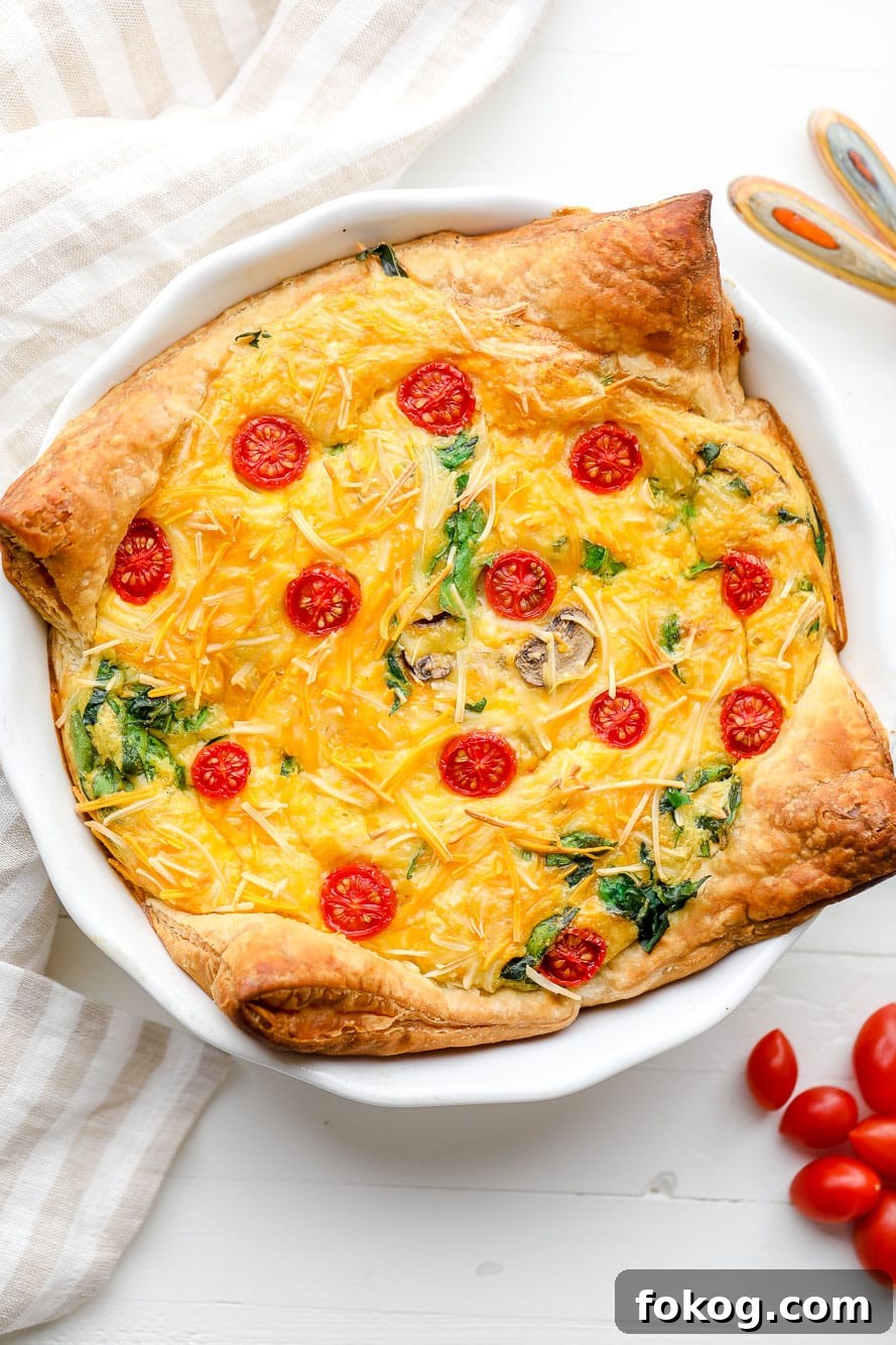 A baked JUST Egg quiche in a white pie plate.