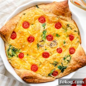 A baked JUST Egg quiche in a white pie plate.