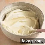 frosting in a bowl with a spatula.