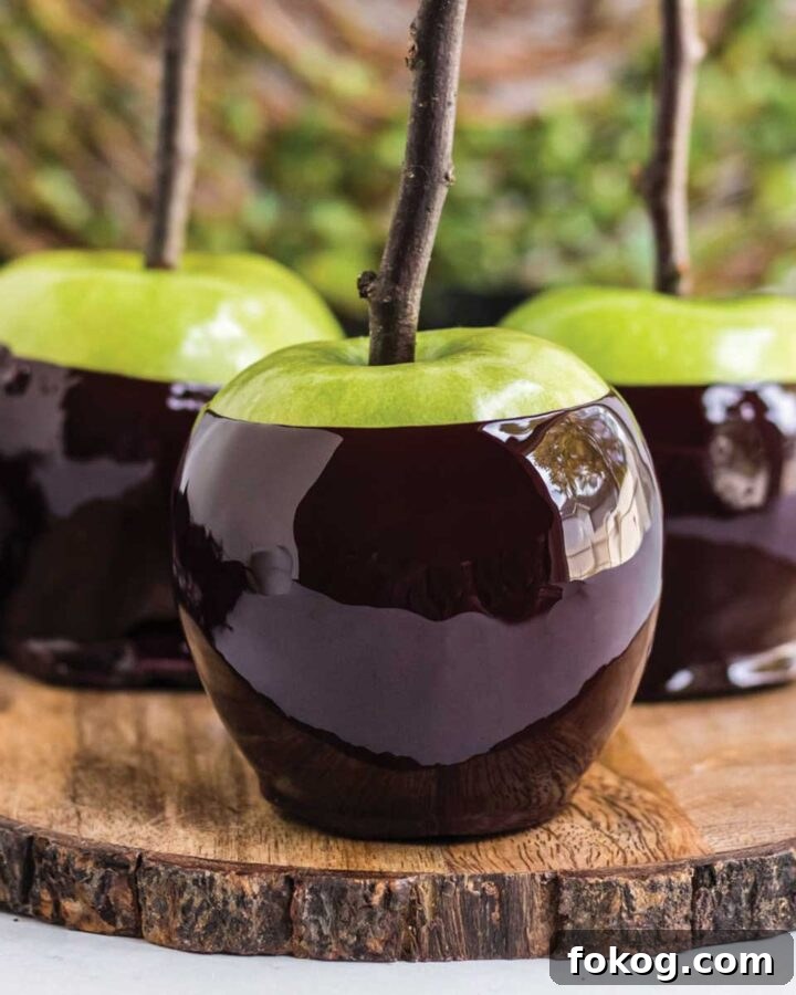 Three poison candy apples on a wood platter