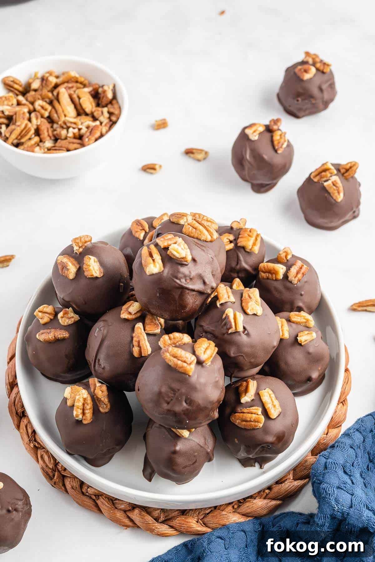 Pecan pie balls piled on to a white plate.