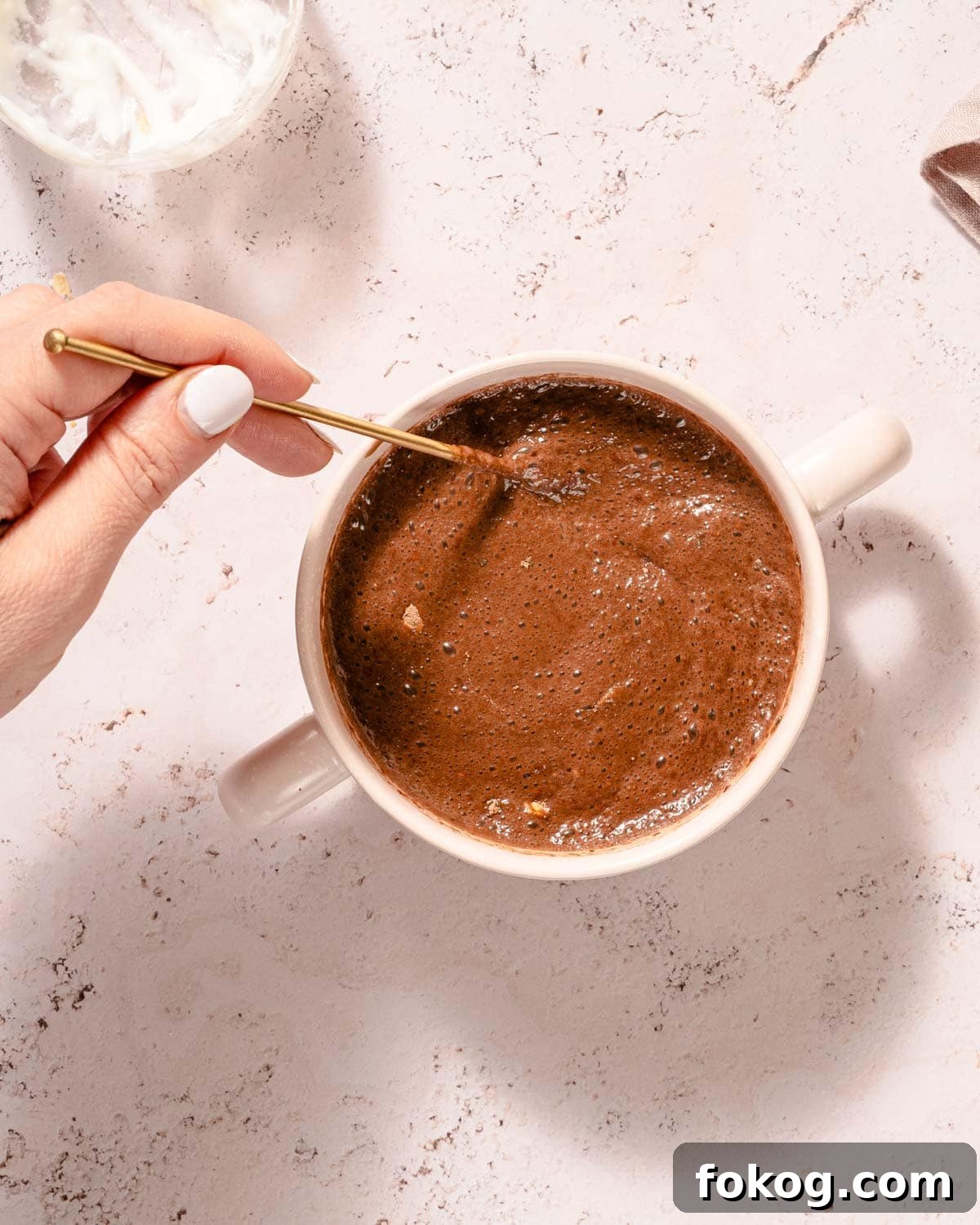 Creamy Chocolate Protein Overnight Oats 6 spoon stirring chocolate protein overnight oats before soaking.