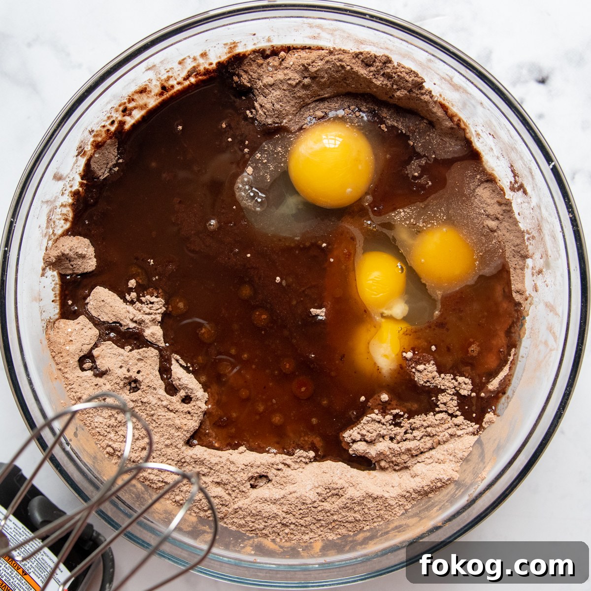 eggs and oil being added to the dry ingredients.