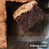 a slice of gluten free zucchini cake facing up in a baking pan