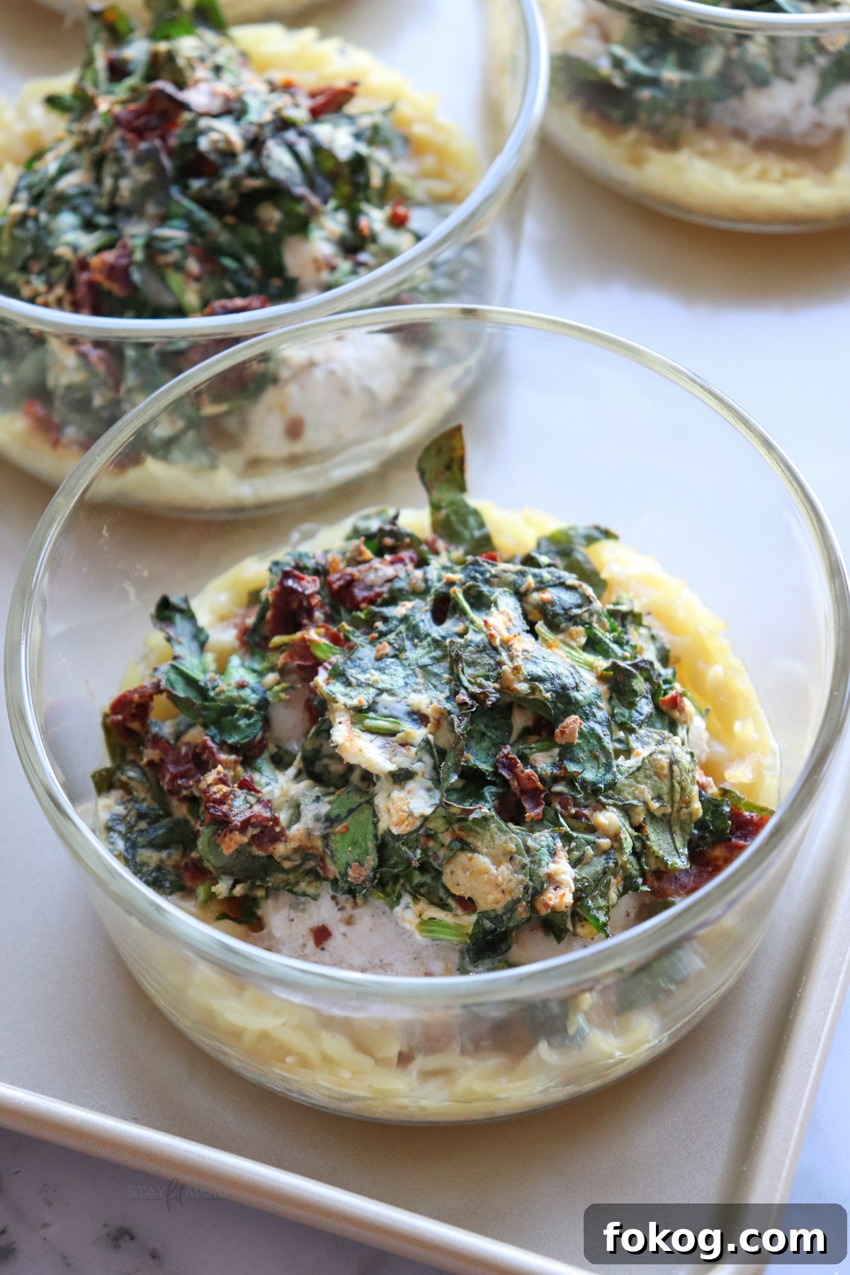 Sun Dried Chicken Orzo Easy Bakes showing completed meal with visible orzo, spinach, and sun dried tomatoes.