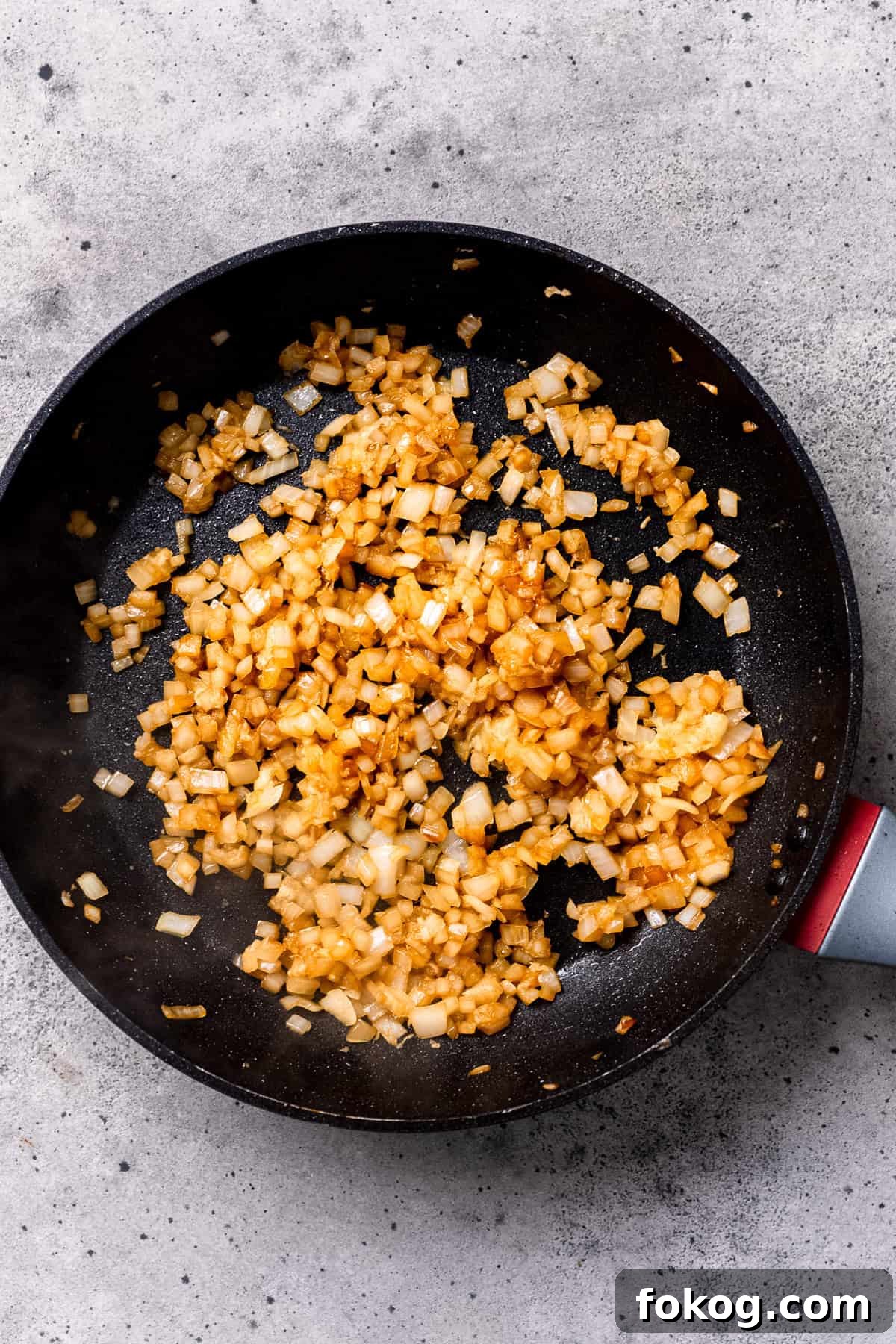 Sautéing onions in a pan for mushroom pork chops.