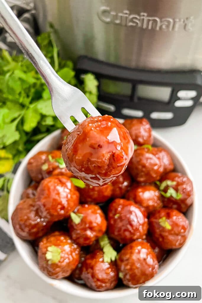 close up photo of a meatball on a fork
