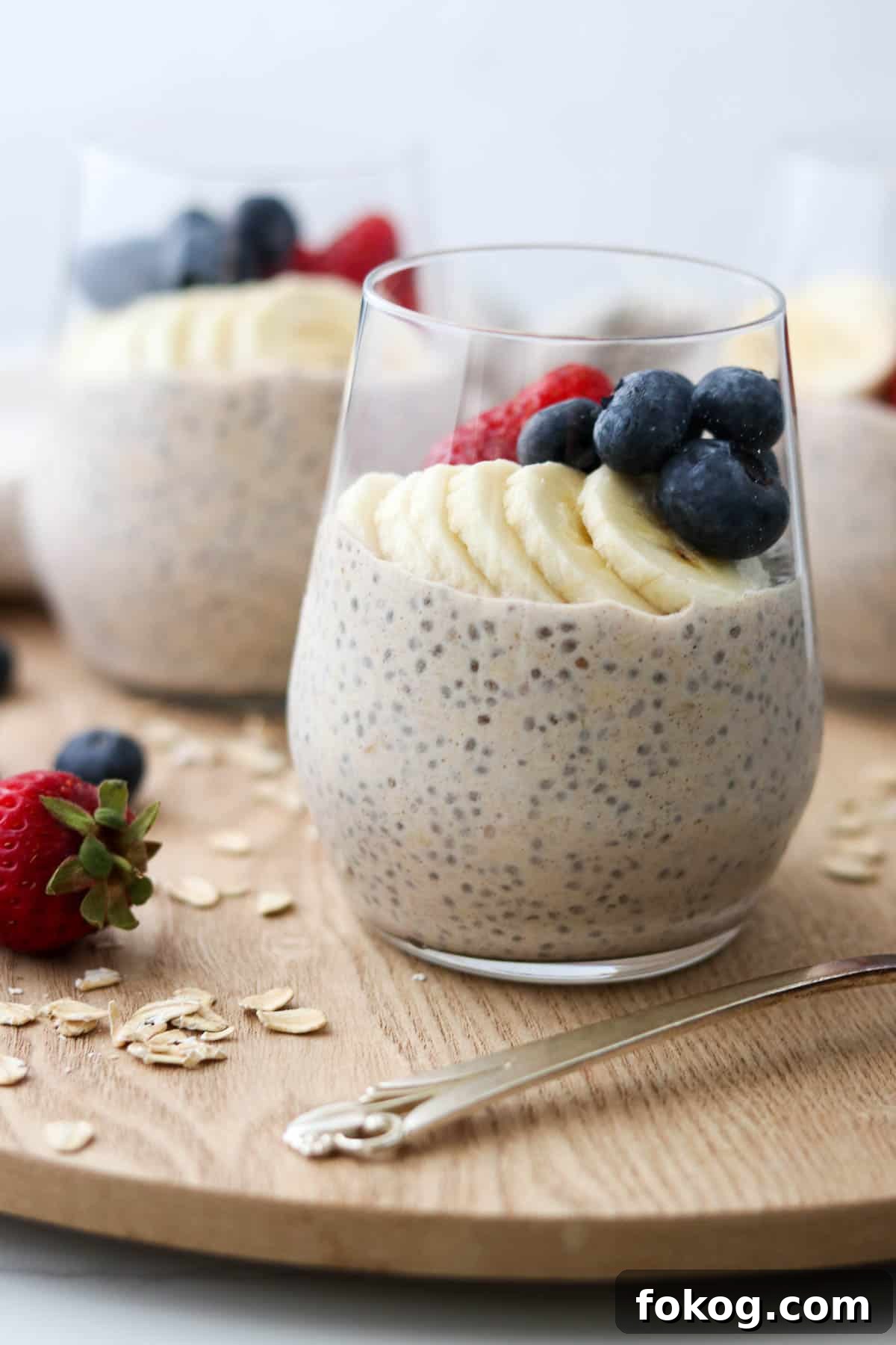 Creamy Vanilla Cinnamon Overnight Oats Recipe 2 Glasses of overnight oats topped with bananas, blueberries and strawberries.