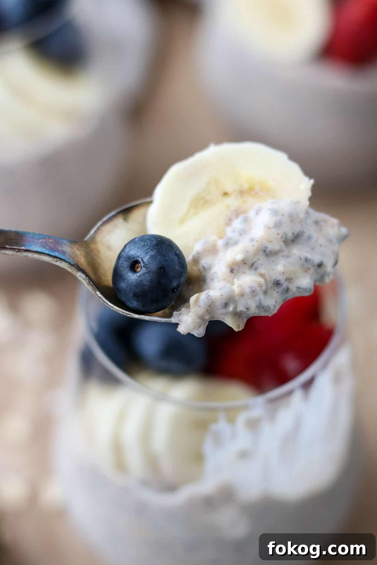 Creamy Vanilla Cinnamon Overnight Oats Recipe 5 A spoonful of overnight oats, a banana slice and a blueberry on a spoon.