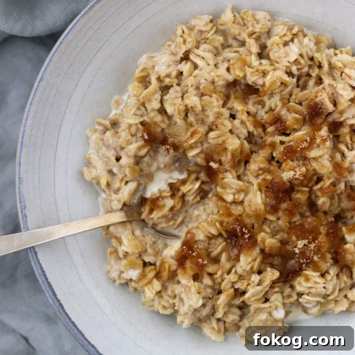 Oatmeal in a bowl with a spoon on a napkin