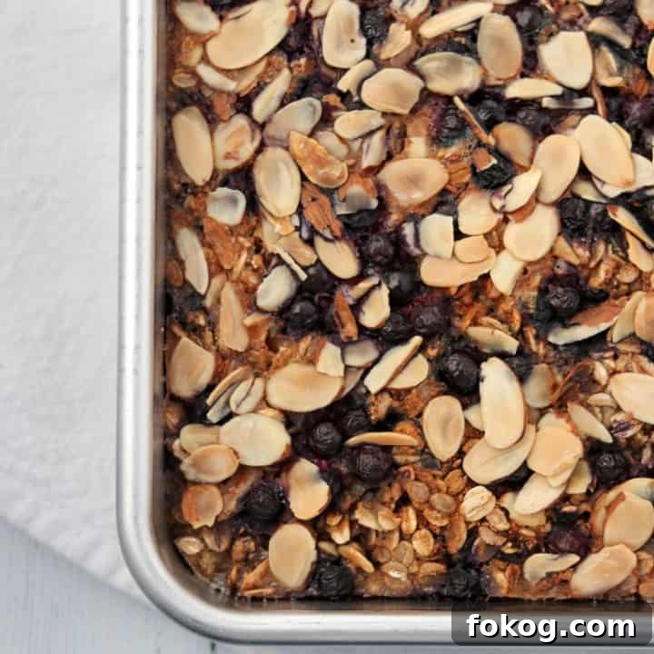 Baked oat and rye porridge with blueberries and almonds in a pan