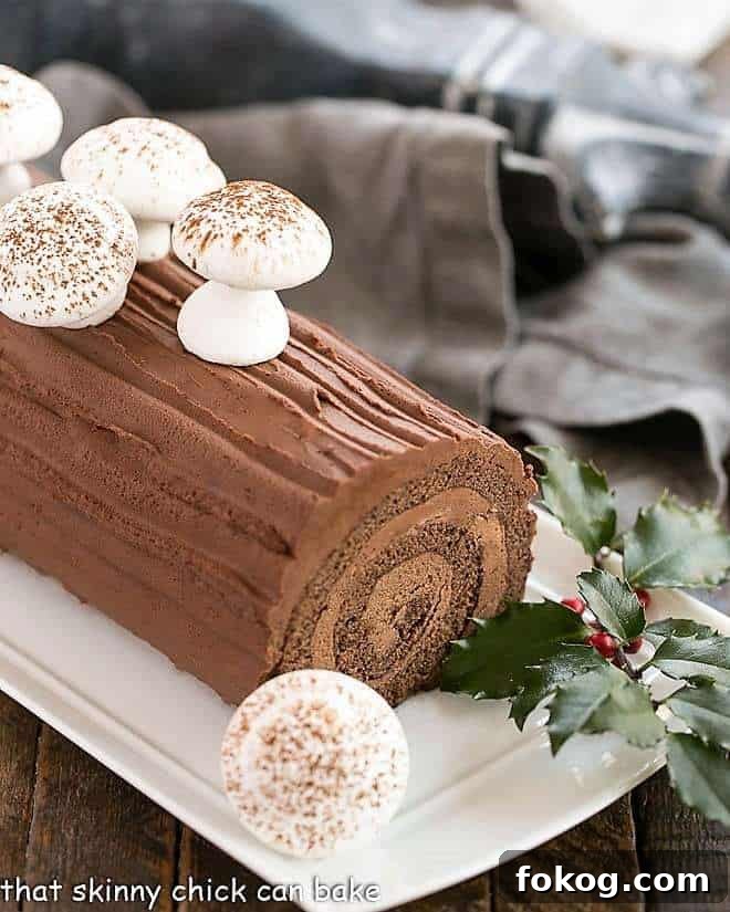 Bûche de Noël garnished with meringue mushrooms and holly.