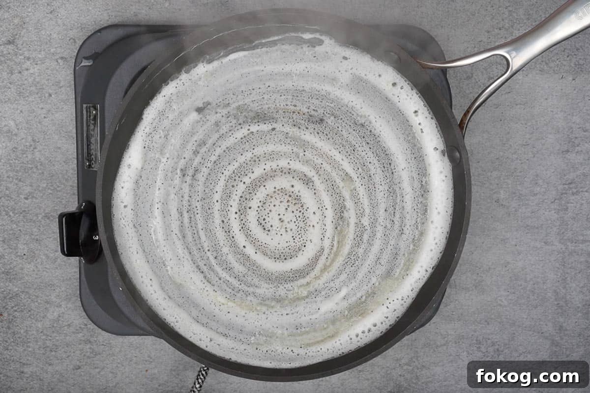 Crispy Egg Dosa (Mutta Dosa) Recipe for Perfect Breakfast 5 Oil drizzled on the side and top of the dosa.
