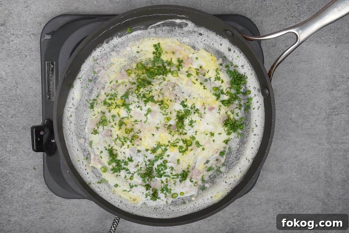 Crispy Egg Dosa (Mutta Dosa) Recipe for Perfect Breakfast 7 Onions, green chilies and cilantro sprinkled over the dosa.