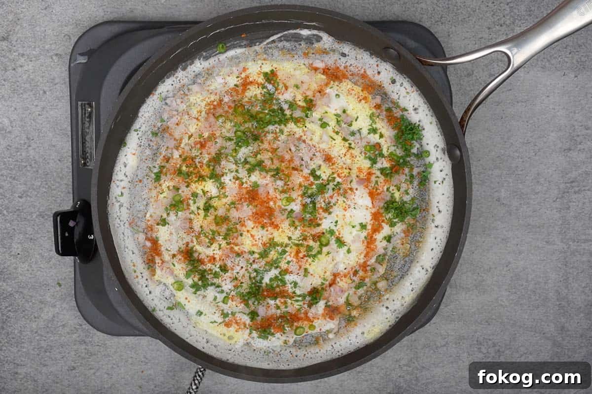 Crispy Egg Dosa (Mutta Dosa) Recipe for Perfect Breakfast 8 Salt and idli podi sprinkled on top.