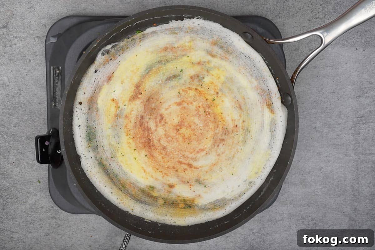 Crispy Egg Dosa (Mutta Dosa) Recipe for Perfect Breakfast 9 Dosa flipped upside down.