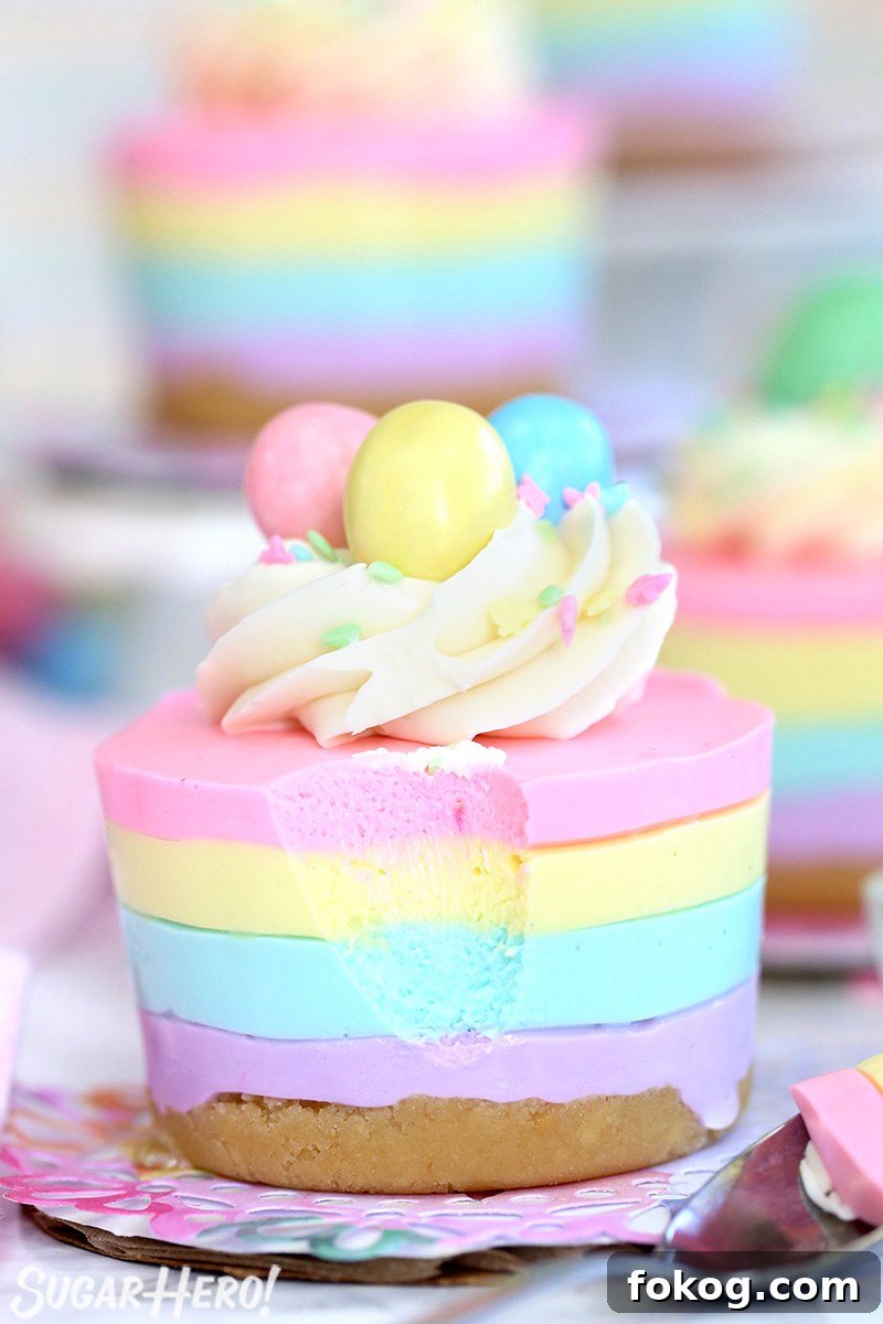 Easter no-bake cheesecake topped with frosting, sprinkles, and candy eggs.
