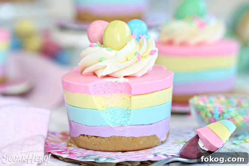 Easter no-bake mini cheesecake topped with frosting, sprinkles, and a candy egg.