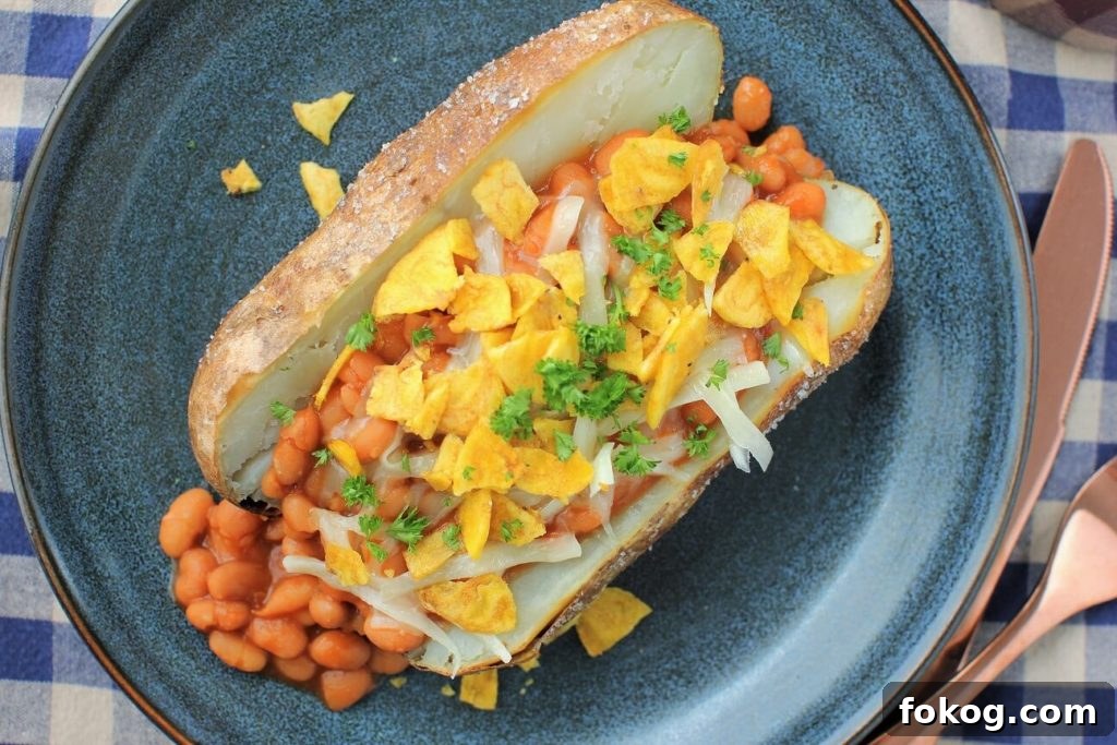 Creamy Tuna Stuffed Baked Potatoes + 44 Savory Topping Ideas 4 baked potato, split and topped with baked beans, cheese, and chips
