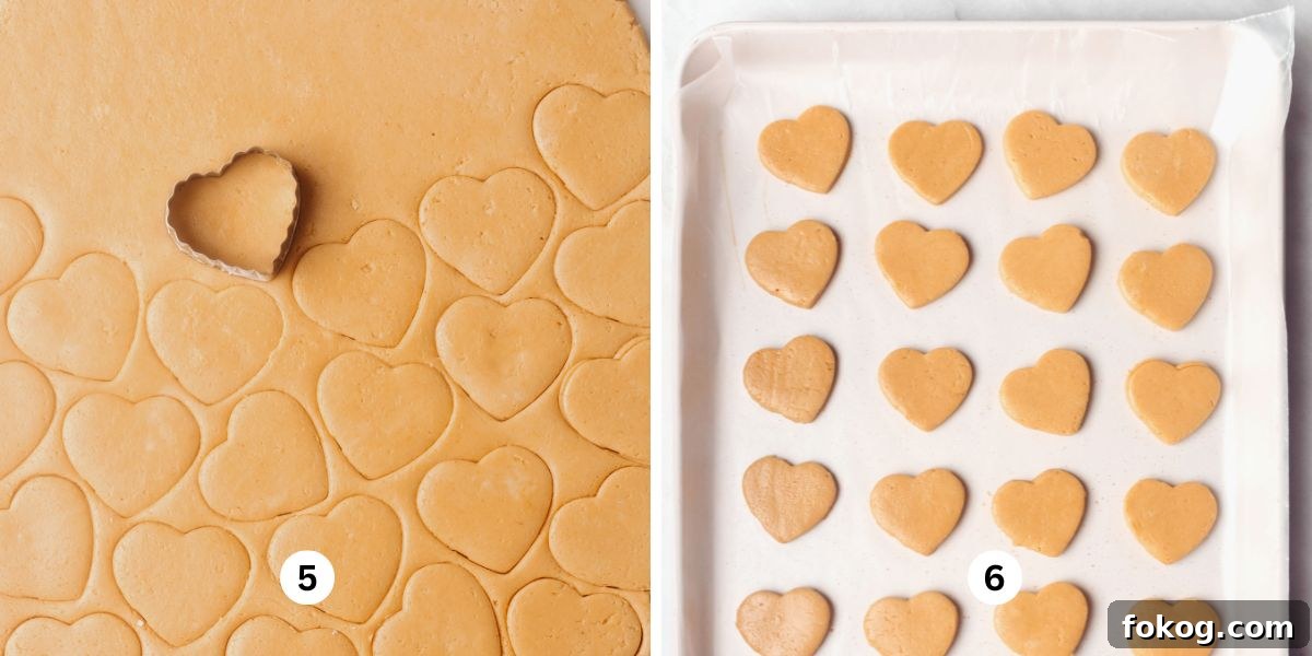 Rolled out peanut butter hearts mixture and cut out peanut butter hearts on wax paper lined baking sheets.
