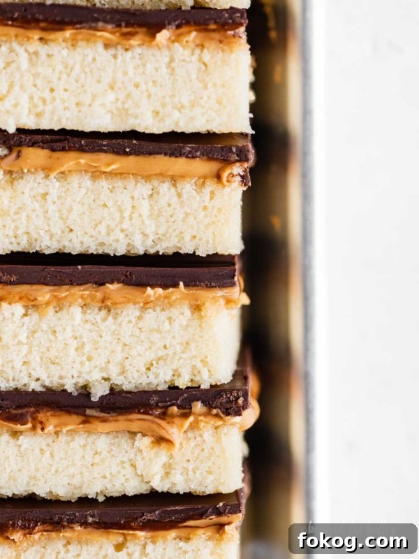 Closeup image of stacked homemade peanut butter kandy kakes on baking sheet.