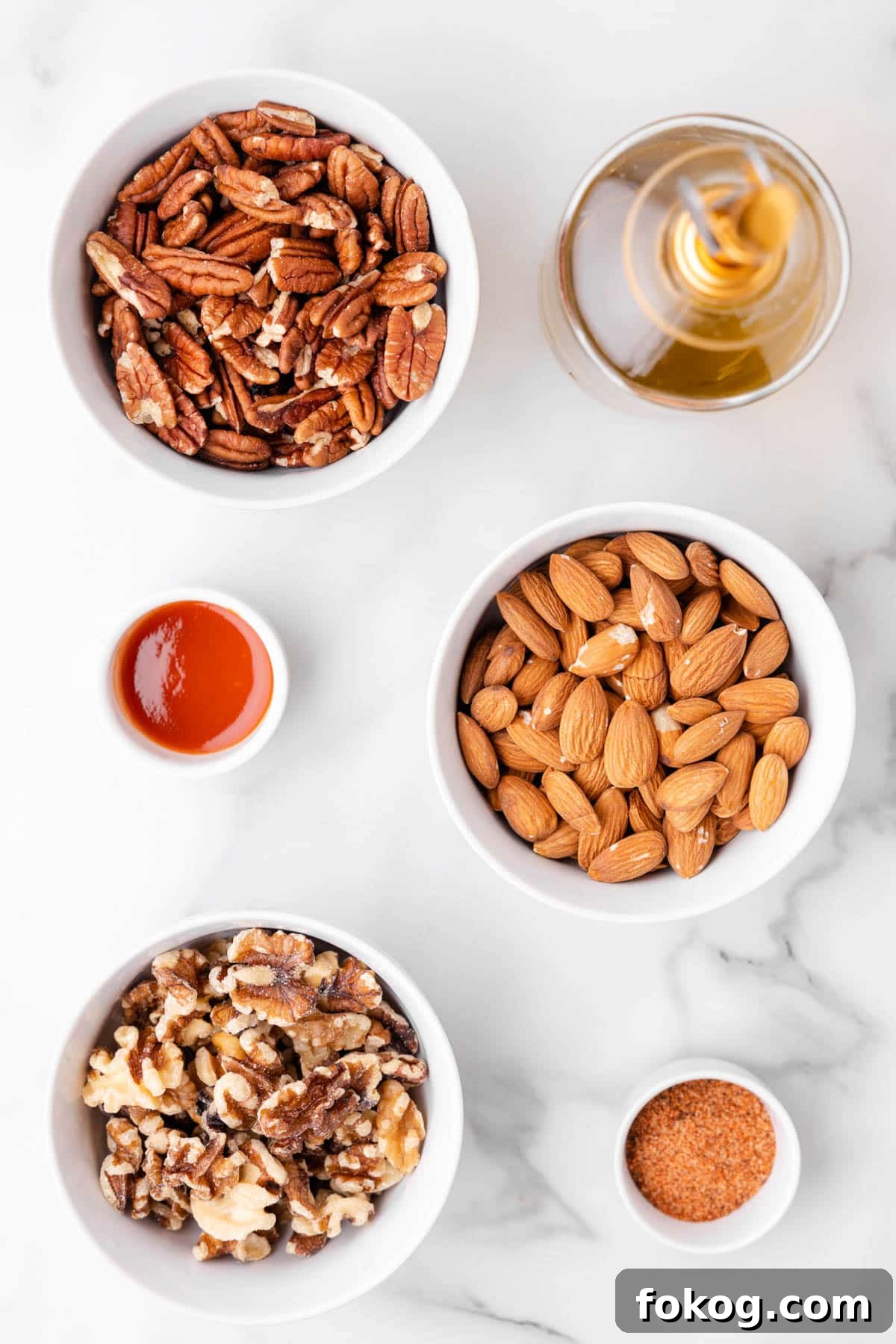 overhead photo of bowls of ingredients needed to make cajun spicy mixed nuts