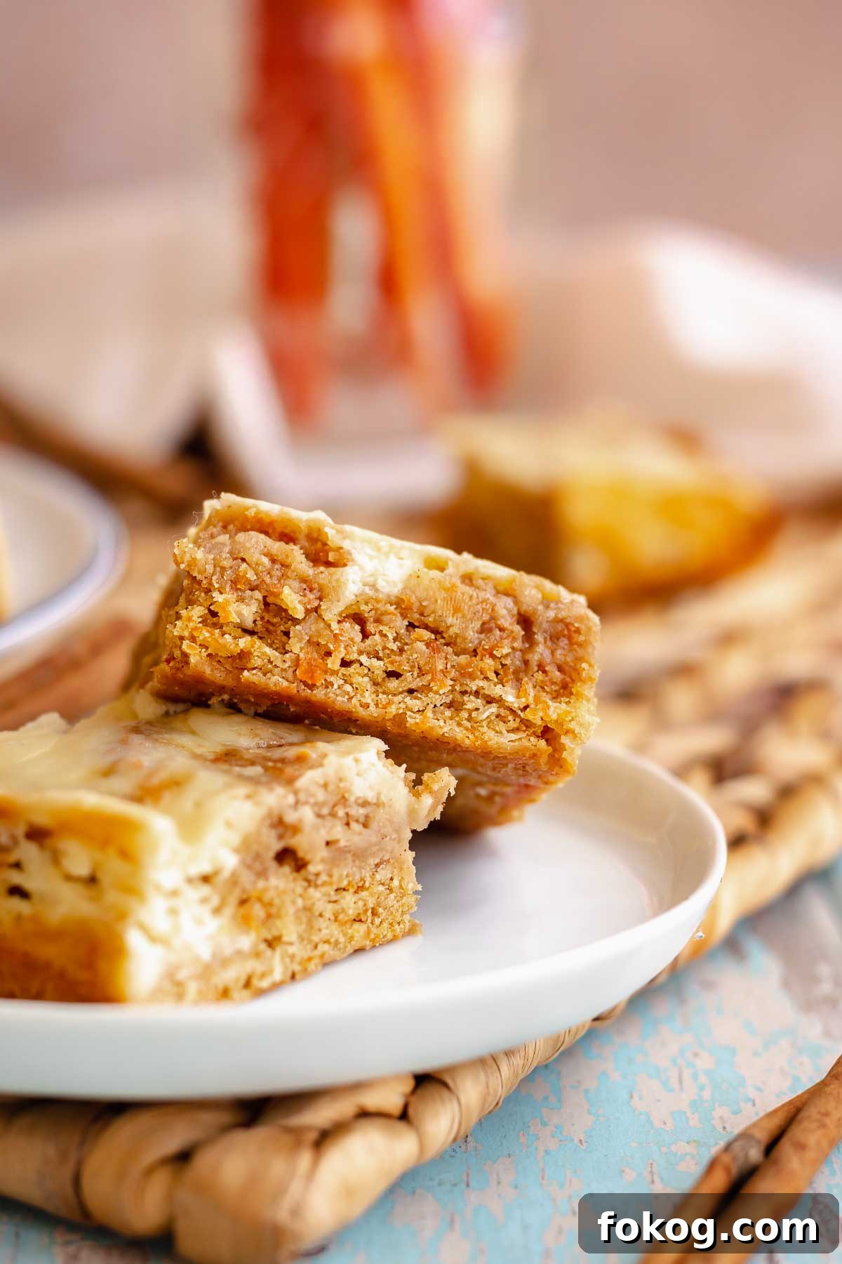 Carrot cake blondies leaning on each other on a plate.