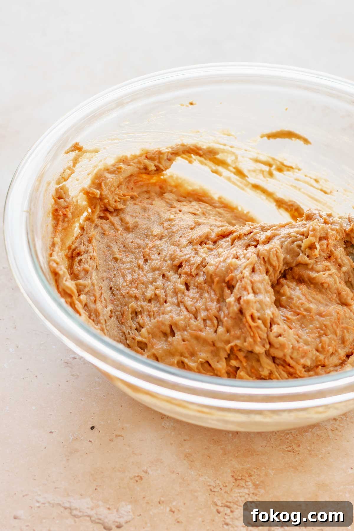 Finished carrot cake batter in a bowl.