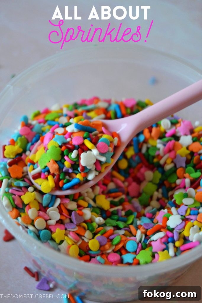 closeup of a rainbow sprinkle blend in a bowl with a pink spoon