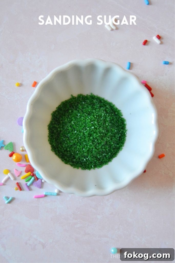 green sanding sugar in a small white bowl