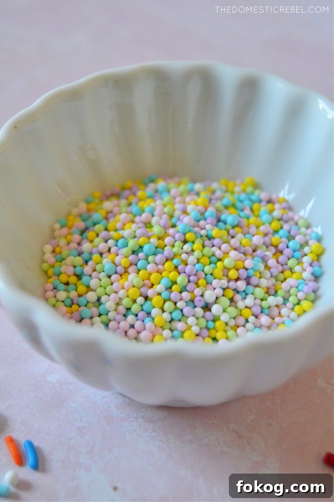 bowl of non-pareils sprinkles on pink background