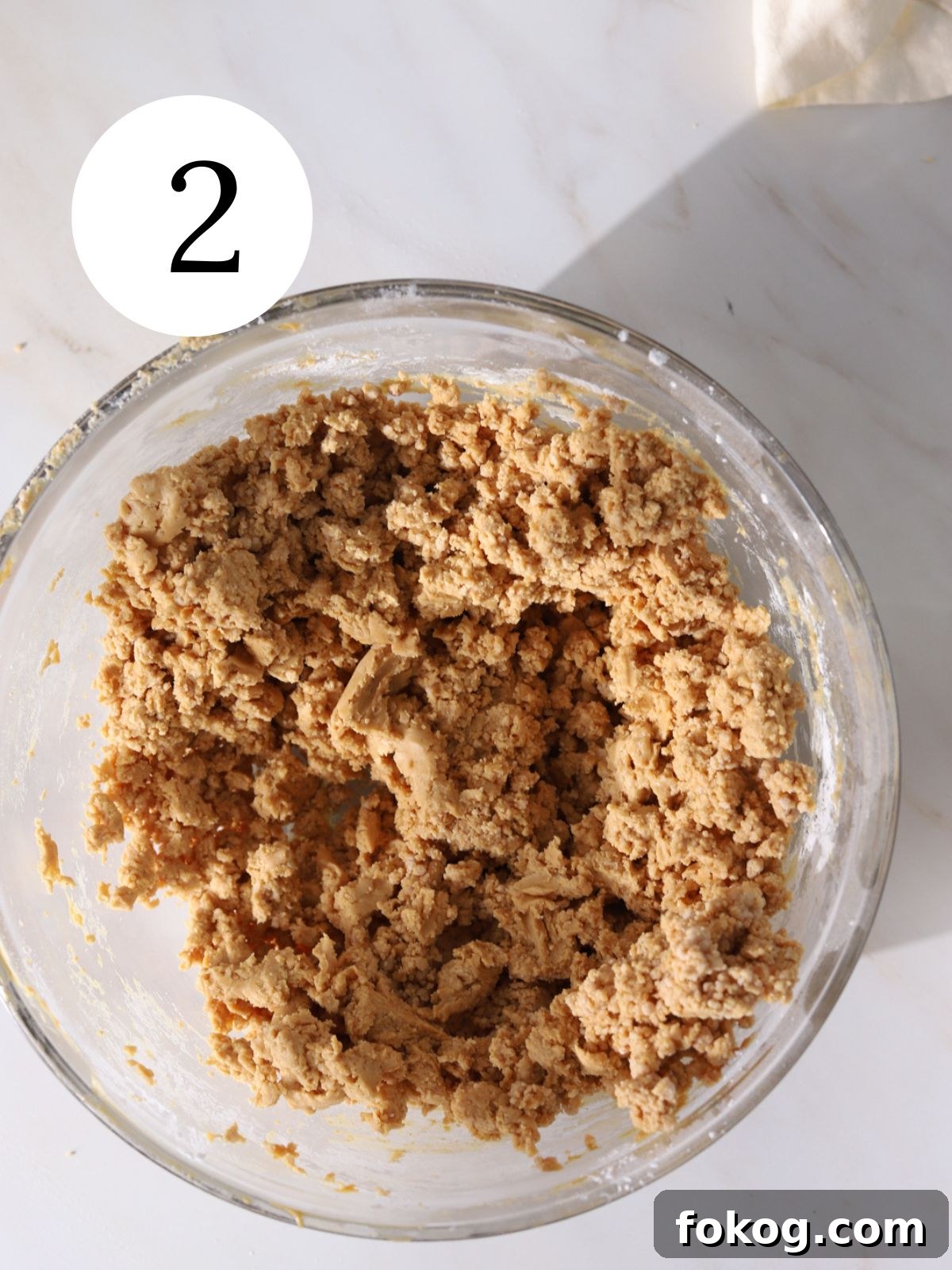 No-Bake Peanut Butter Balls Recipe: Quick Treats for Parties 5 Peanut butter mixed with butter in a bowl.