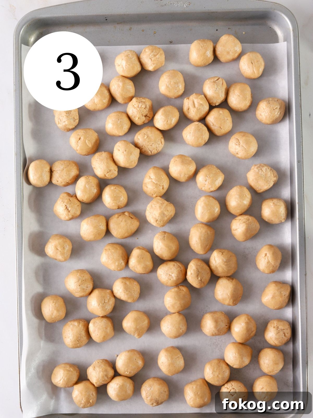No-Bake Peanut Butter Balls Recipe: Quick Treats for Parties 6 Peanut butter balls on a baking sheet