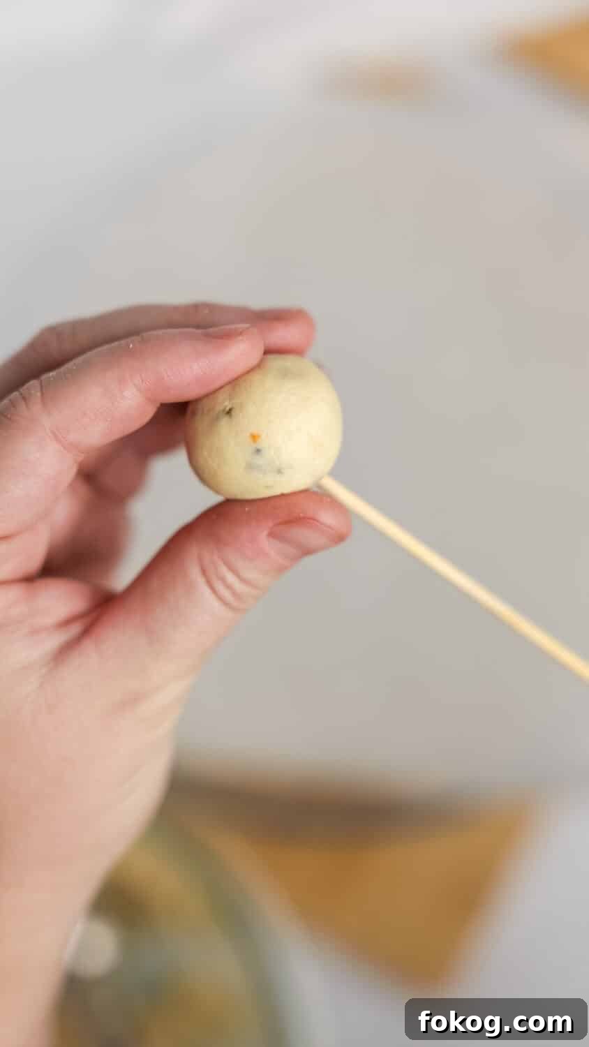 Keto Cottage Cheese Cake Pops Recipe — Low-Carb Dessert Bite 9 skewering one cake pop