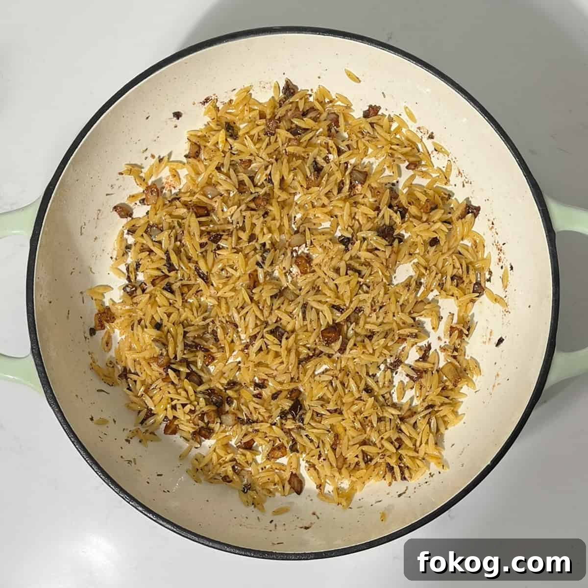 Creamy Lemon Chicken Orzo — One-Pot Weeknight Dinner 11 Toasting orzo with onions for the lemon chicken orzo pasta.