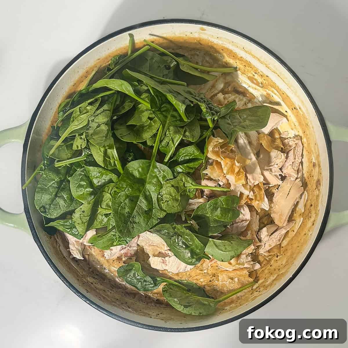 Creamy Lemon Chicken Orzo — One-Pot Weeknight Dinner 14 Adding spinach and parmesan to the lemon chicken orzo pasta in a large saucepan.