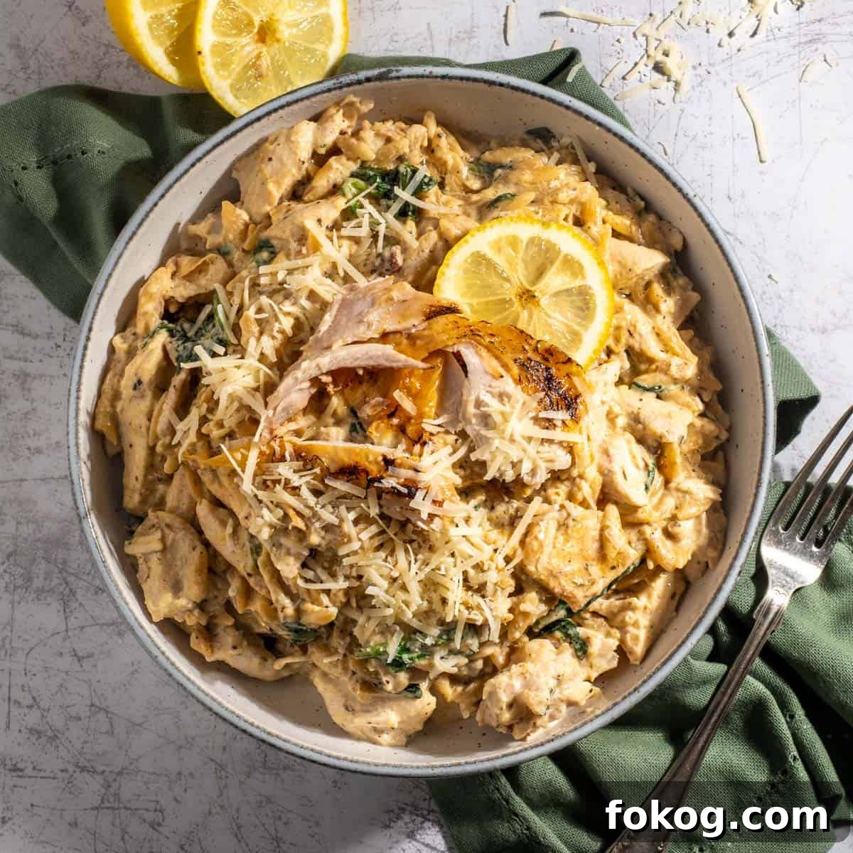 Creamy Lemon Chicken Orzo — One-Pot Weeknight Dinner 17 Lemon chicken orzo pasta with some sliced lemon.