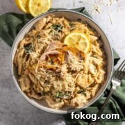 Creamy Lemon Chicken Orzo — One-Pot Weeknight Dinner 18 Lemon chicken orzo pasta with some sliced lemon.