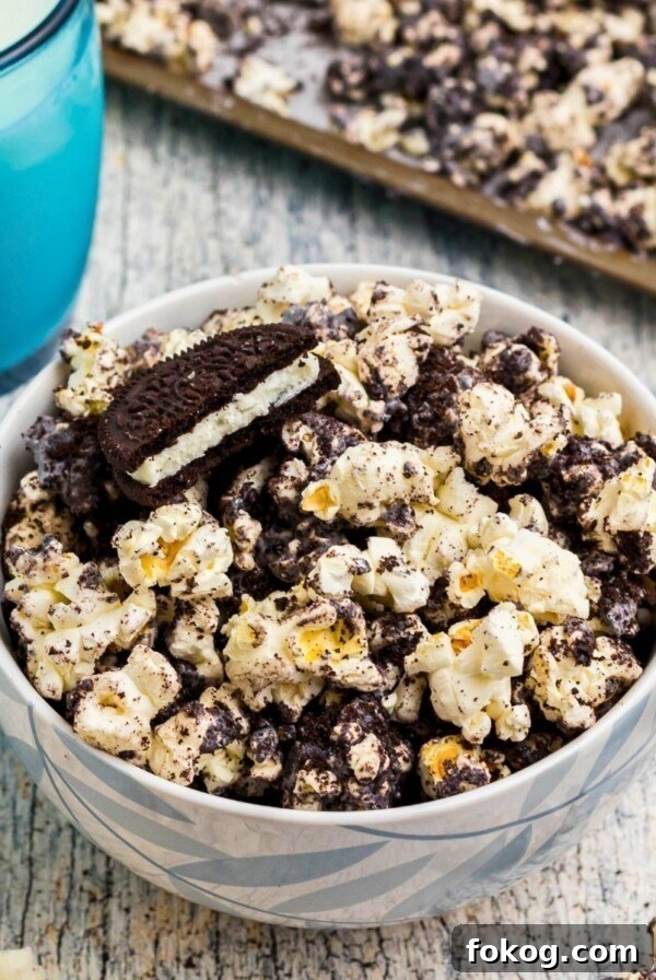 Sweet Grape Jelly Meatballs with Tangy Glaze Recipe 12 Popcorn combined with melted white chocolate and Oreo cookies crushed, with glasses of milk on the table.