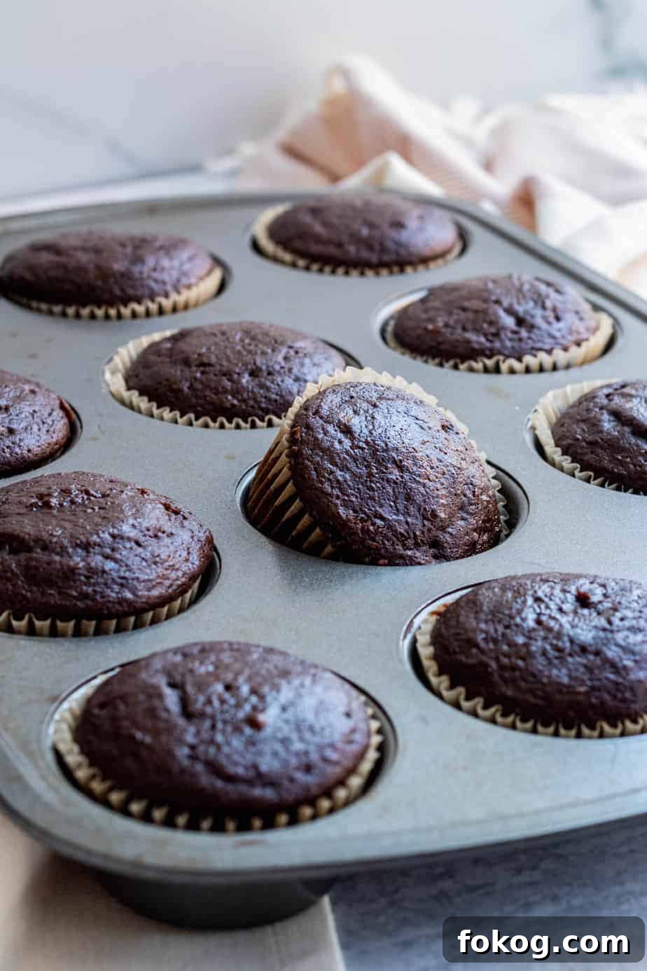 cupcake pan with baked chocolate cupcakes