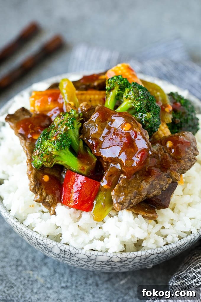 Hunan Beef Recipe | Beef Stir Fry A bowl of Hunan beef stir fry over rice.