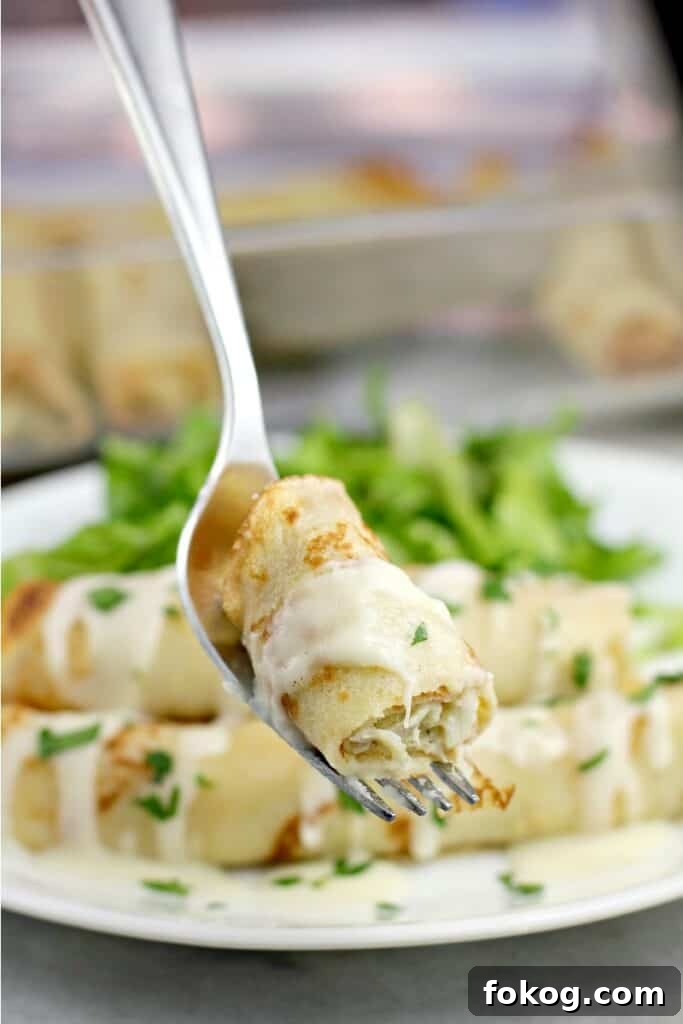 Smoked Salmon Crepes Recipe with Creamy Dill Filling 12 bite of crab crepe on a fork