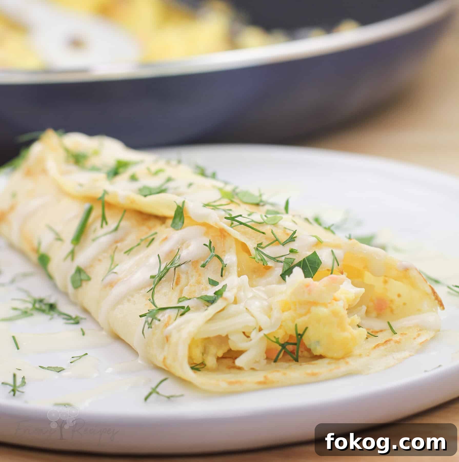 Smoked Salmon Crepes Recipe with Creamy Dill Filling 15 close view of prepared serving of crepe on white dish