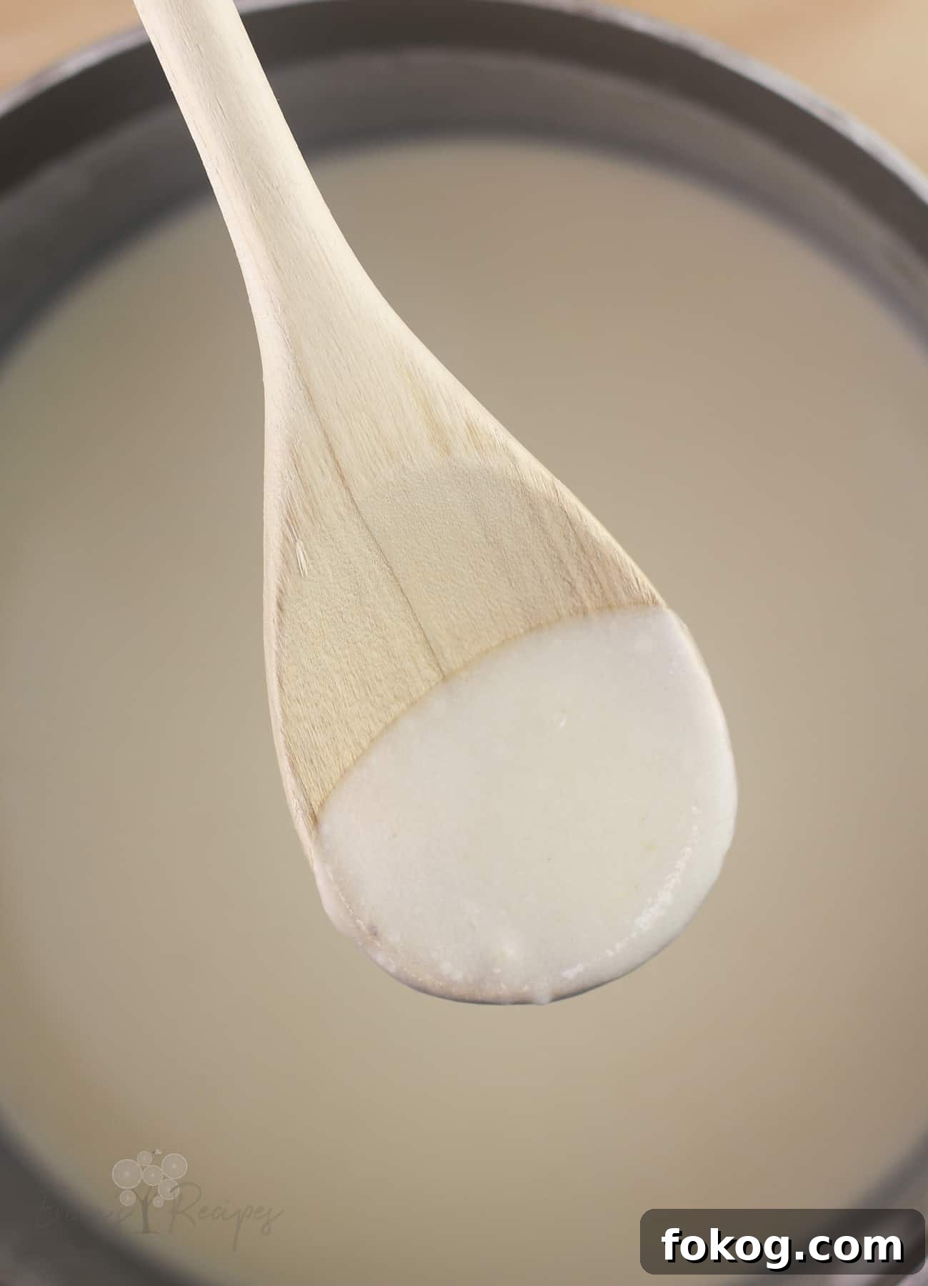 Smoked Salmon Crepes Recipe with Creamy Dill Filling 5 wood spoon with sauce to show thickness
